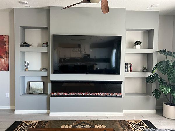 Modern media wall design with floating shelving and ambient concealed lighting