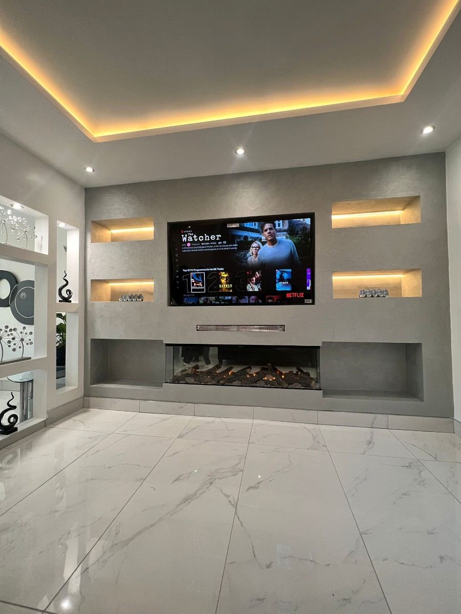 The Manhattan — bespoke full wall media wall with illuminated shelving and ambient LED lighting